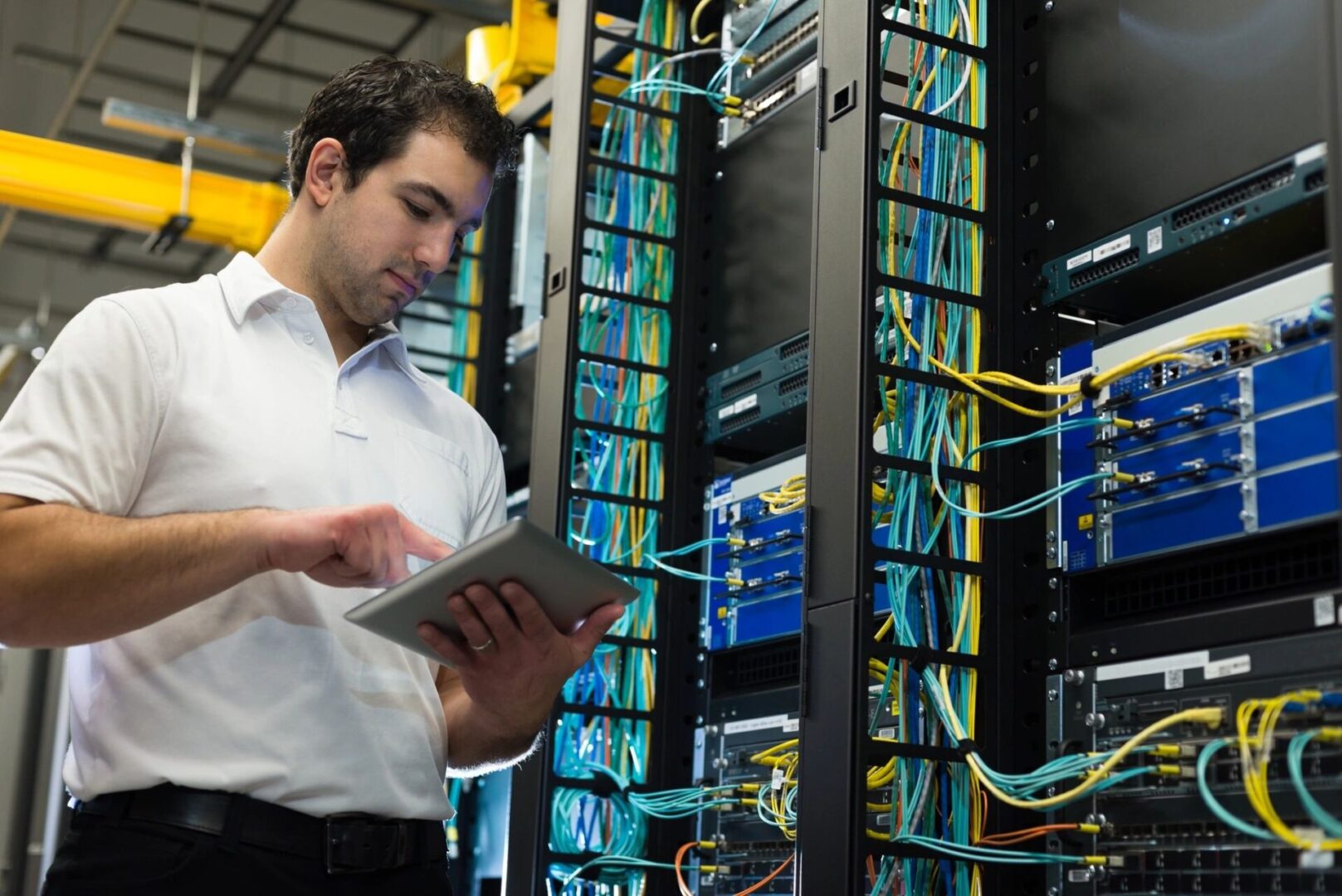 Guy Tapping Tablet Near Communication Hardware Systems